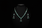 Emerald AD tennis necklace set promotional banner on black background