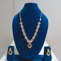 Gold polki AD heart pendant necklace set on navy velvet display