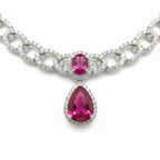 Close-up macro of AD curb chain links and ruby double-drop pendant