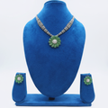Black bead and AD emerald green daisy pendant necklace set on navy velvet display