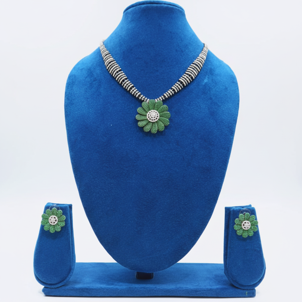 Black bead and AD emerald green daisy pendant necklace set on navy velvet display
