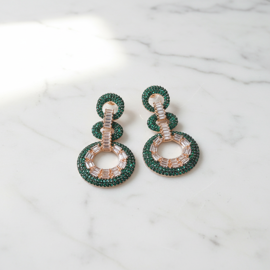 Emerald Green Fan Baguette CZ Double Circle Earrings – luxury flat lay on marble