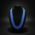 5-strand royal blue crystal bead necklace on dark velvet studio display
