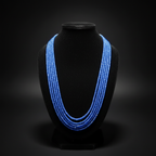 5-strand royal blue crystal bead necklace on dark velvet studio display