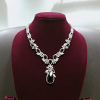 White AD and black onyx floral leaf pendant necklace set on burgundy velvet display