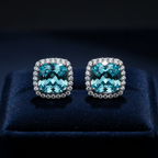 Aqua blue CZ cushion square halo stud earrings on dark navy velvet - dramatic editorial style