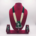 Emerald bead and pearl AD floral pendant long necklace set on burgundy velvet display