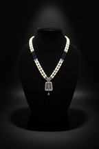 Pearl and AD pendant necklace set with earrings on dark velvet studio display