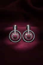 Ruby and diamond oxidised circle drop earrings editorial on burgundy silk