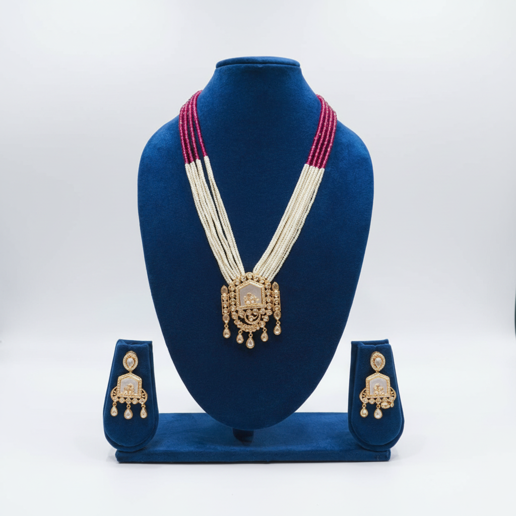 Ruby pink bead and pearl gold polki pendant long necklace set on navy velvet display