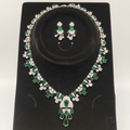 White AD and emerald green mixed-cut cluster graduated necklace set on black velvet display