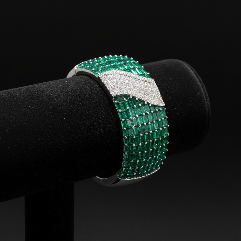 Emerald baguette and white AD pavé wave bangle bracelet on dark velvet studio display