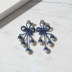 Royal Blue CZ Floral Bow Crystal Ball Drop Chandelier Earrings – luxury flat lay on marble