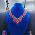 Ruby pink and gold AD V-shape fringe waterfall necklace set on navy velvet display