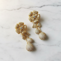 Luxury gold flower drop earrings editorial promotional image