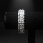 All-white baguette AD bangle with round polki AD border on dark velvet studio display