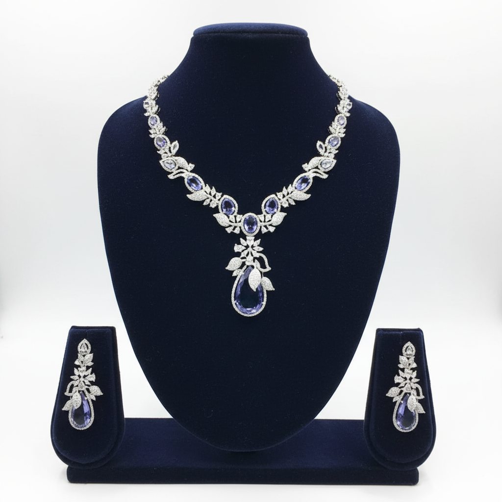 White AD and tanzanite blue floral leaf pendant necklace set on navy velvet display