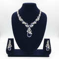 White AD and tanzanite blue floral leaf pendant necklace set on navy velvet display