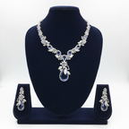 White AD and tanzanite blue floral leaf pendant necklace set on navy velvet display