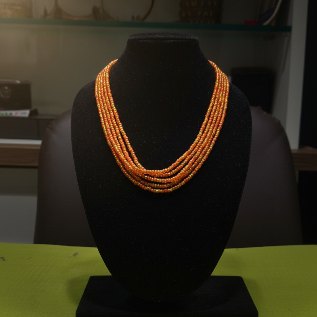 5-strand orange and gold seed bead necklace on dark velvet studio display