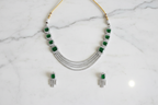 Emerald multi-strand AD necklace set flat lay on white marble