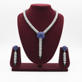 AD sapphire and emerald spiral shell necklace set on burgundy velvet display