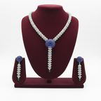 AD sapphire and emerald spiral shell necklace set on burgundy velvet display