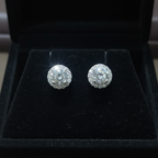 White CZ round cluster halo stud earrings on black velvet - dark editorial style