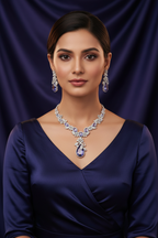 Lifestyle shot — model wearing white AD and tanzanite blue floral leaf pendant necklace set