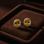 Golden citrine CZ oval halo stud earrings on espresso brown velvet - dark editorial style