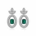 Emerald solitaire drop earrings on white background studio shot