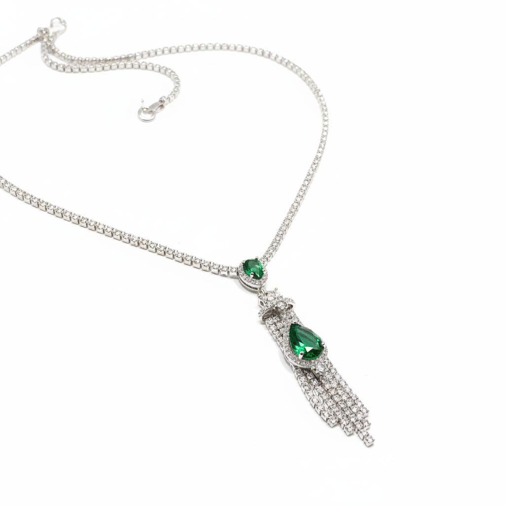 Close-up of emerald teardrop pendant and crystal tassels