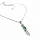 Close-up of emerald teardrop pendant and crystal tassels