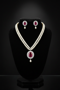 2-strand seed pearl choker with ruby oval AD pendant on dark velvet studio display