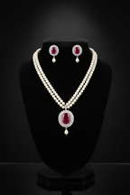 2-strand seed pearl choker with ruby oval AD pendant on dark velvet studio display