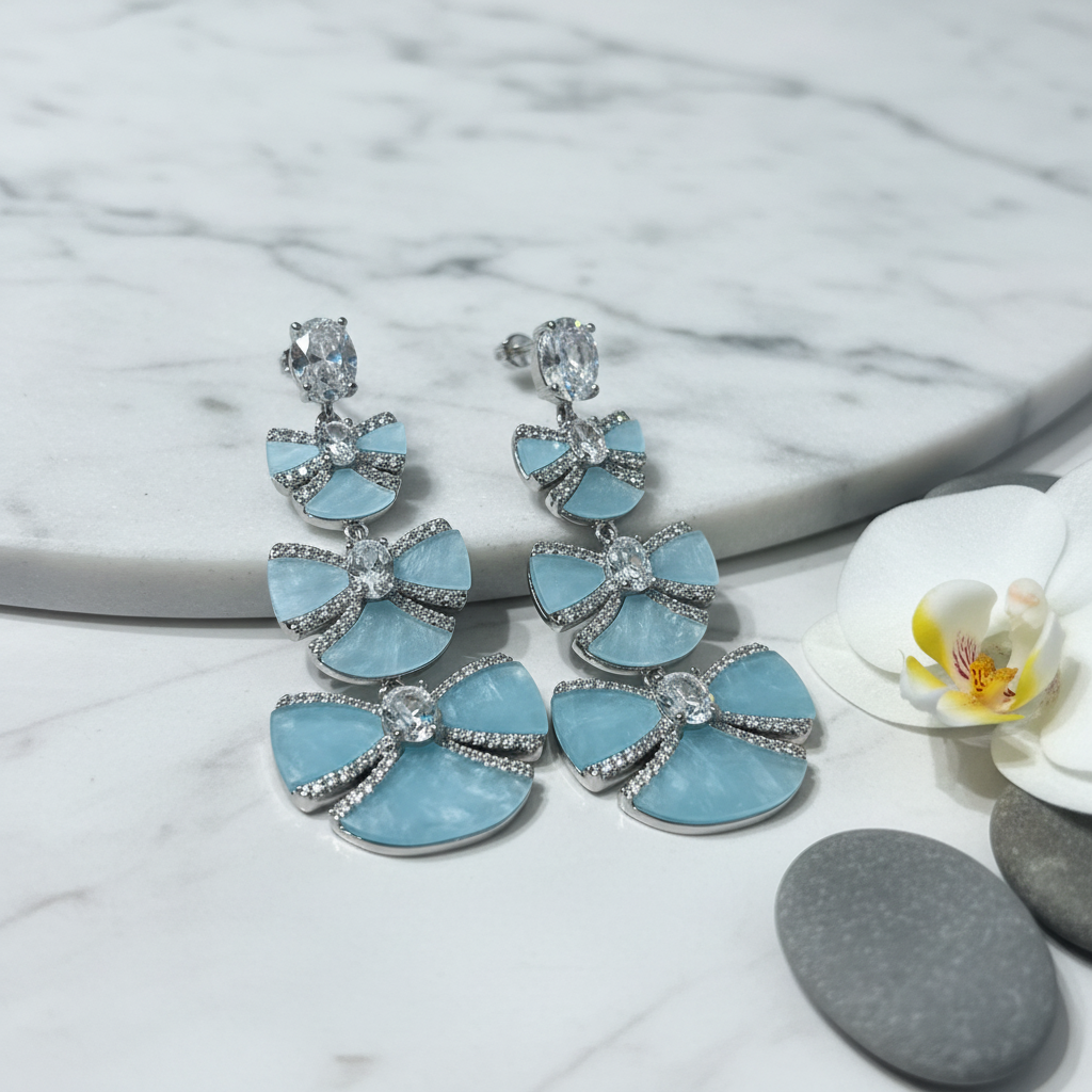 Silver CZ Triple Bow Drop Earrings – luxury flat lay on marble