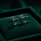 Emerald green CZ cushion square solitaire stud earrings on forest green velvet - dark editorial style