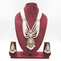 Multi-strand pearl waterfall and polki AD shield pendant long necklace set on burgundy velvet display