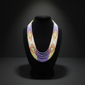 7-strand white and multicolor seed bead necklace on dark velvet studio display