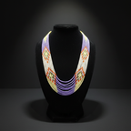 7-strand white and multicolor seed bead necklace on dark velvet studio display