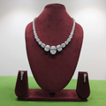 White AD mixed-cut graduated tennis necklace set with pear drop earrings on burgundy velvet display