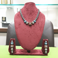 Multicolour AD square stone graduated choker necklace set on burgundy velvet display