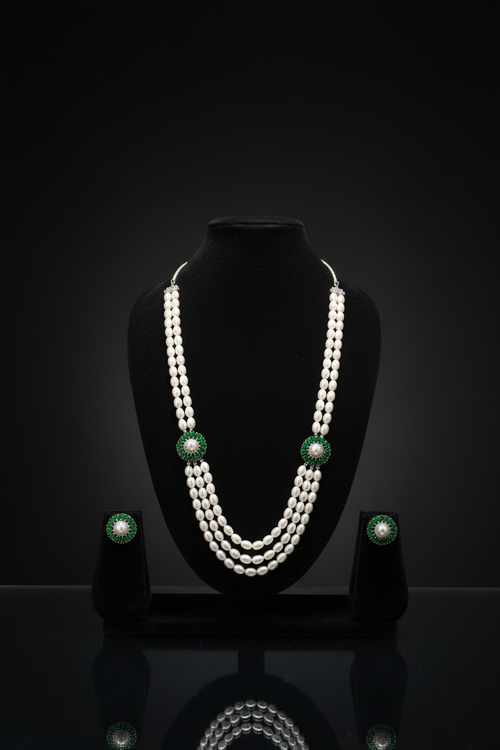 3-strand pearl long necklace with emerald floral AD stations on dark velvet studio display