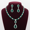 Emerald AD tennis necklace set on burgundy velvet display