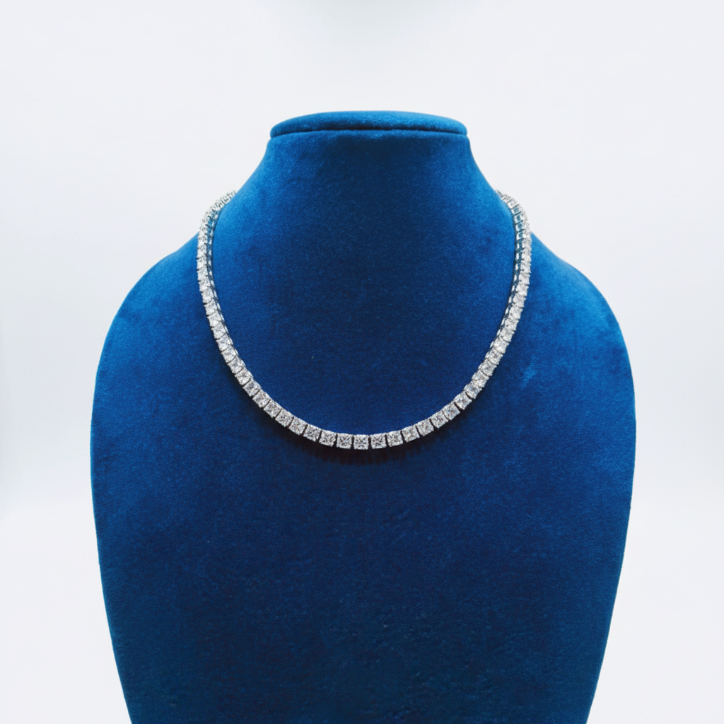 White AD graduated tennis necklace set with linear bar earrings on navy velvet display