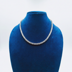 White AD graduated tennis necklace set with linear bar earrings on navy velvet display