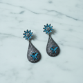 Turquoise Daisy & Black CZ Teardrop Earrings – luxury flat lay on marble