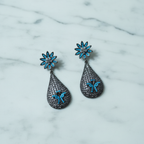 Turquoise Daisy & Black CZ Teardrop Earrings – luxury flat lay on marble