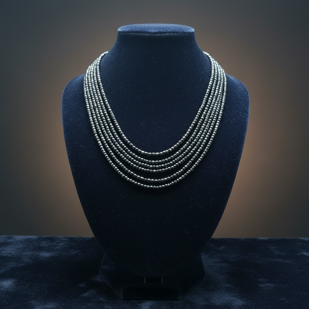 Hematite necklace on dark velvet studio display