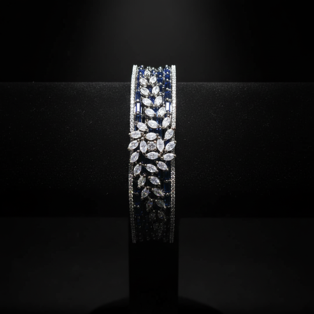 Navy blue baguette AD bangle with white marquise leaf overlay on dark velvet studio display
